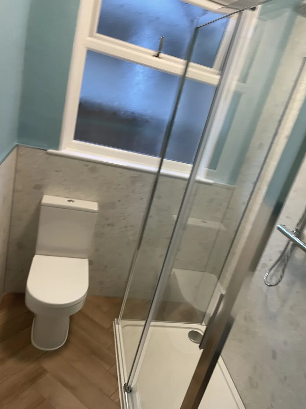 Shower room refurbishment with corner enclosure and herringbone flooring